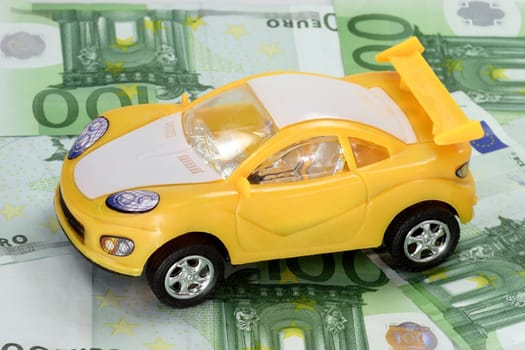 White and yellow Toy Car on Euro Banknotes