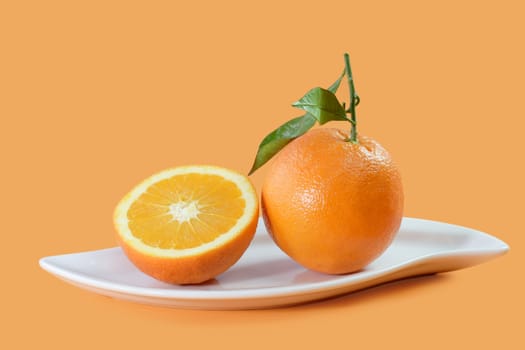 Orange Juice with Fruits on a plate on orange Background