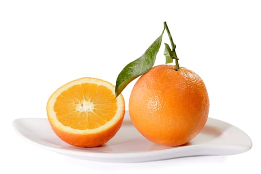 Fresh Oranges on a white plate on bright Background