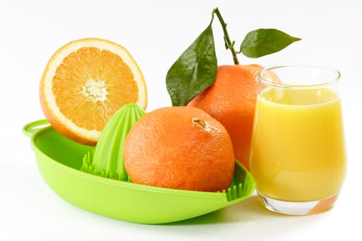 Orange Juice with fruits and a green juicer