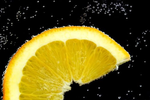 Splashing slice lemon in water on black background
