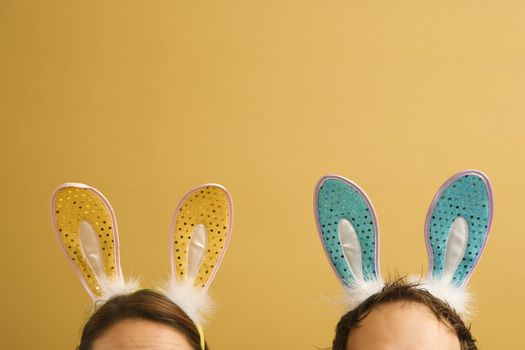 Caucasian mid adult couple wearing rabbit ears.