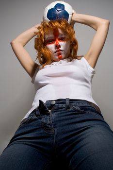 english football makeup girl holding worn soccer ball, ready to attack