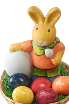 Close up of a basket with multicolored easter eggs and a bunny