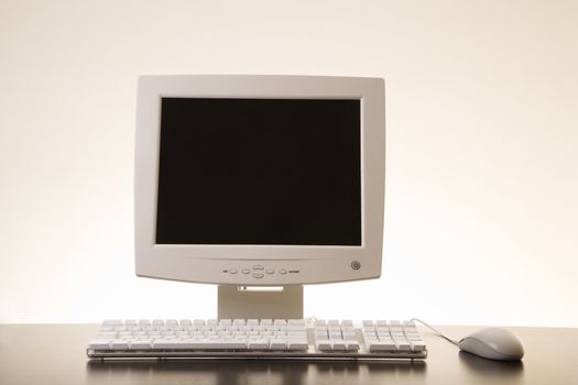 Still life of computer monitor, keyboard and mouse.