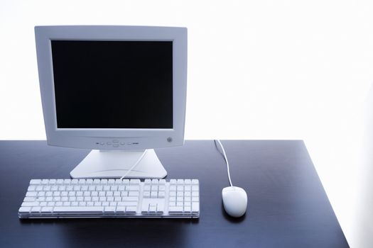 Still life of computer monitor, keyboard and mouse.