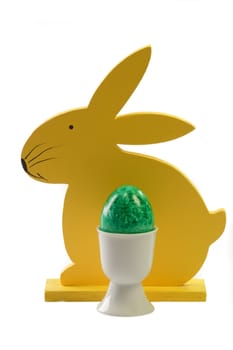 Yellow wooden easter bunny with green easter egg