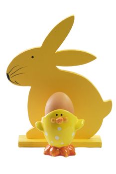 Yellow wooden easter bunny with an easter egg on bright background