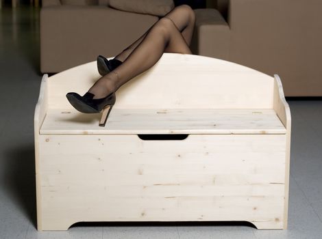 woman legs over wooden box