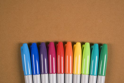 Group of colorful markers lined up in a row.