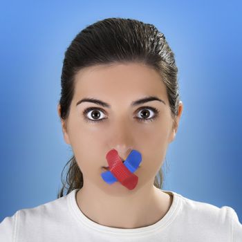 Beautiful woman with a colored cross bandage on the mouth