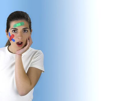 Beautiful woman with a surprised face beacuse of th over a blue background