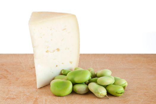 cutting board with pecorino cheese and broad beans isolated on white background with clipping path