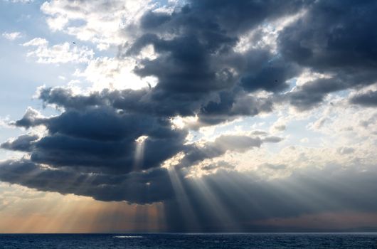 rays of sun through the clouds over the sea