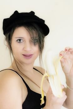 a sexy woman in her underwear peeling a banana 