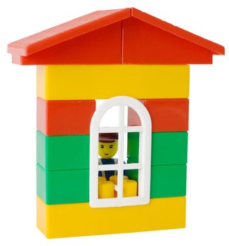 Little man and toy house on the white background