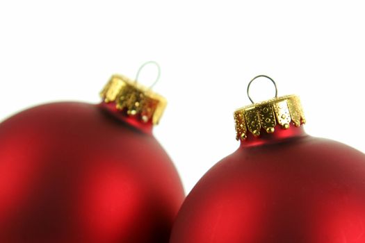 A closeup of a pair of red Christmas baubles closeup.