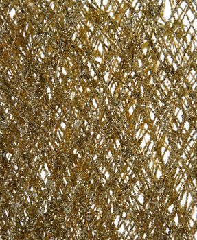 A close up of a gold glitter decoration.
