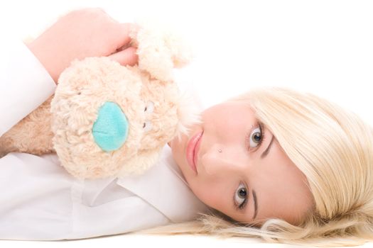 Cute girl lying on a floor with teddy bear