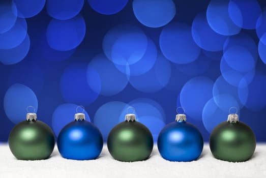 Christmas balls on the snow.  Background - blue christmas lights. aRGB.