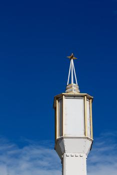 Decco White and Gold Lamp with star on top against deep blue sky