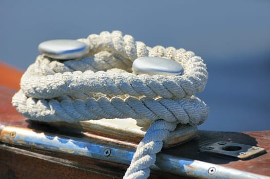 Close-up of a rope tied-up on a bitt fasten a boat to dock