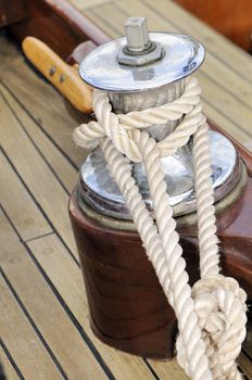 Close-up of a winch on a wooden sailboat