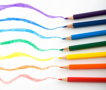 Crayons with drawn trace from them on the white background