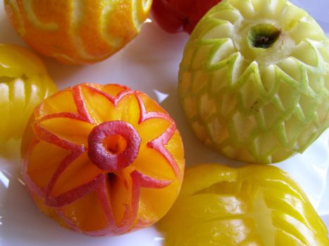 the beautifully carve fruits is on the festive table. 