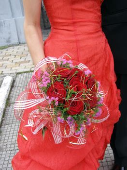 the girl has beautiful bouquet in her hand. 