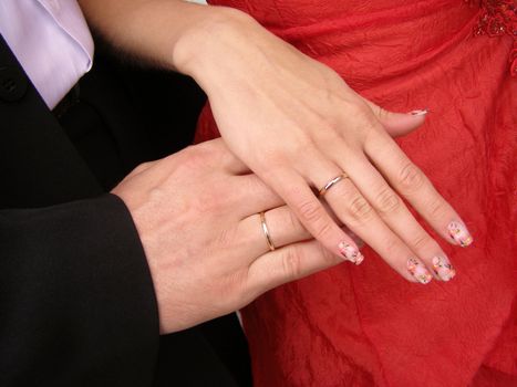 the fiance and the bride has wedding rings on their hands