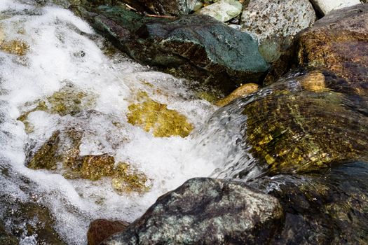 Stones and foam in a stream 
