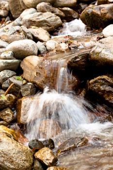 A small waterfall surrounded by stones
