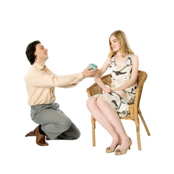 A girl and a man giving her a globe