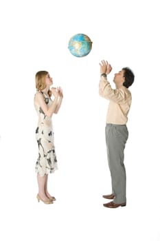 Man and woman playing with a big globe