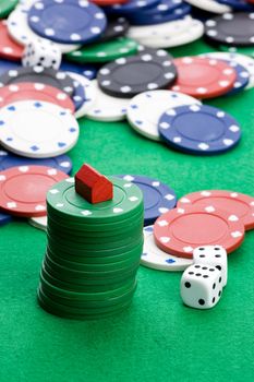 Casino chips with toy house - housing market gamble concept