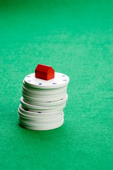 Casino chips with toy house - housing market gamble concept