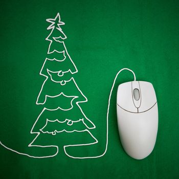Online christmas shopping concept, mouse on green background with christmas tree