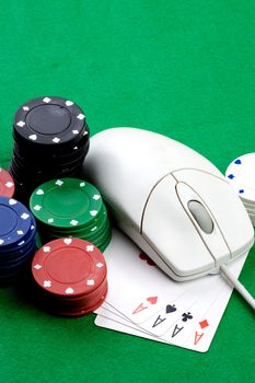 Online gaming and gambling concept, green felt, a mouse and cards