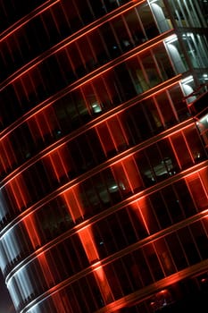 Illuminated skyscraper facade at night in downtown