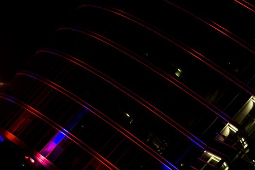 Illuminated skyscraper facade at night in downtown