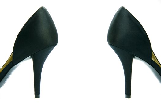 A pair of high heel shoes isolated against a white background