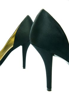 A pair of high heel shoes isolated against a white background