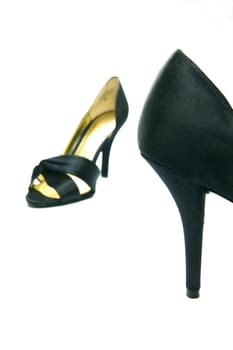A pair of high heel shoes isolated against a white background