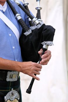 Close up of someone playing a bagpipe