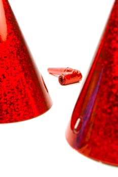 Party hats and blowers isolated against a white background