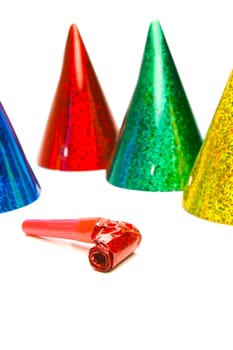 Party hats and blowers isolated against a white background