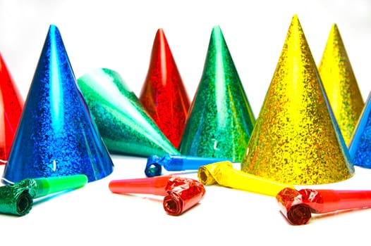 Party hats and blowers isolated against a white background