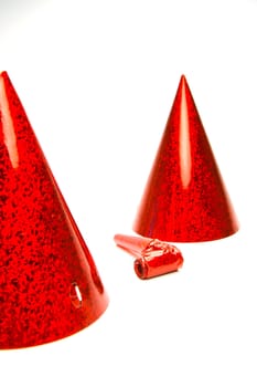 Party hats and blowers isolated against a white background