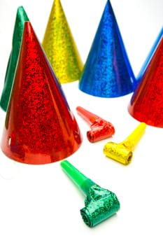 Party hats and blowers isolated against a white background